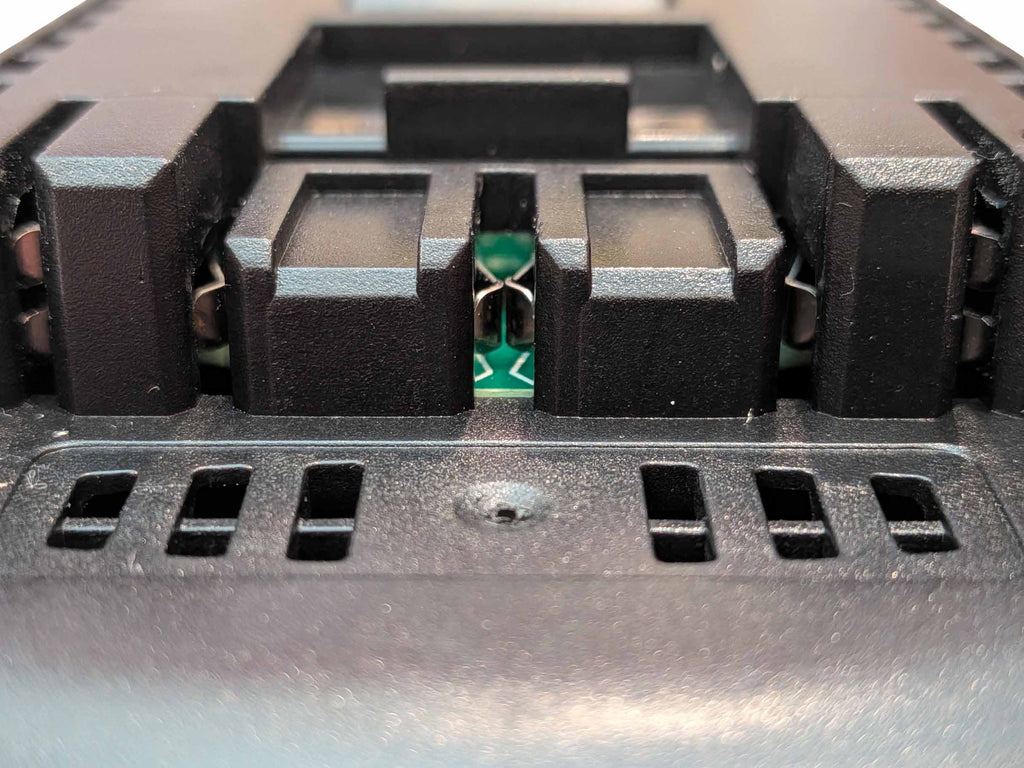 Milwaukee M18 to Bosch 18V GBA (Blue) battery adapter - close-up of the Bosch tool-side terminal slots and copper contacts