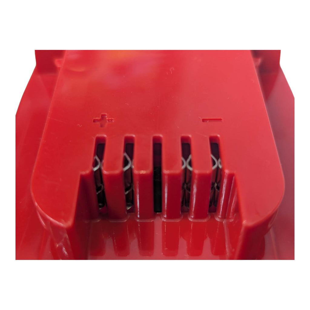 Porter Cable 20V to Milwaukee M18 battery adapter - close-up of the tool-side terminal slots with + and - polarity marks