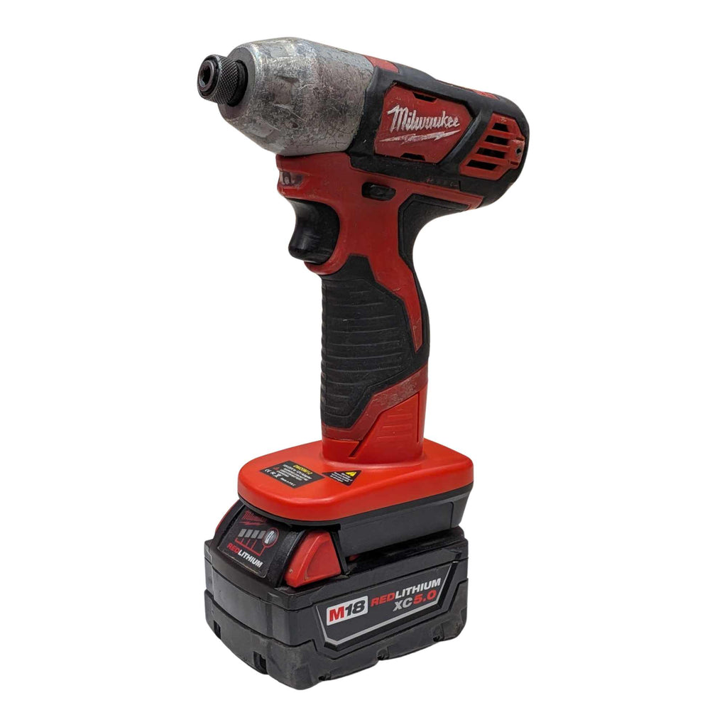 Milwaukee M18 to Milwaukee M12 battery adapter - installed on an impact driver and fitted to the battery, front view