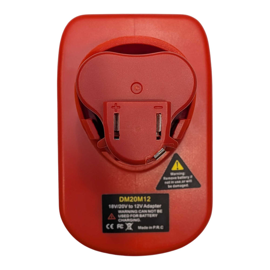 Milwaukee M18 to Milwaukee M12 battery adapter - tool-side face from above with two terminal slots, polarity marks alongside