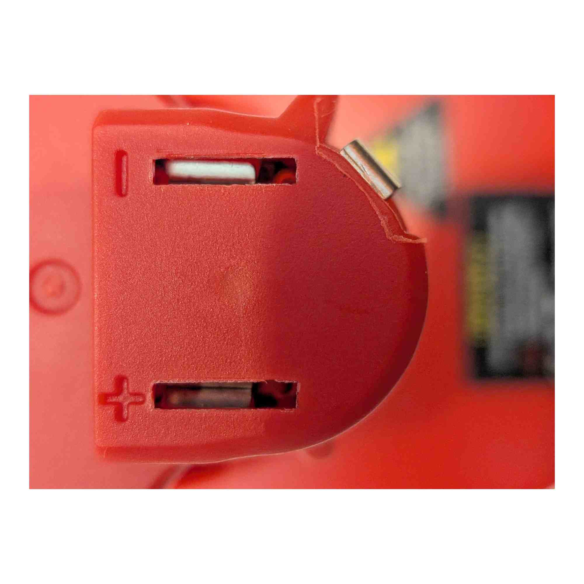 Milwaukee M18 to Milwaukee M12 battery adapter - close-up of the tool-side connection, terminal slots and polarity marks