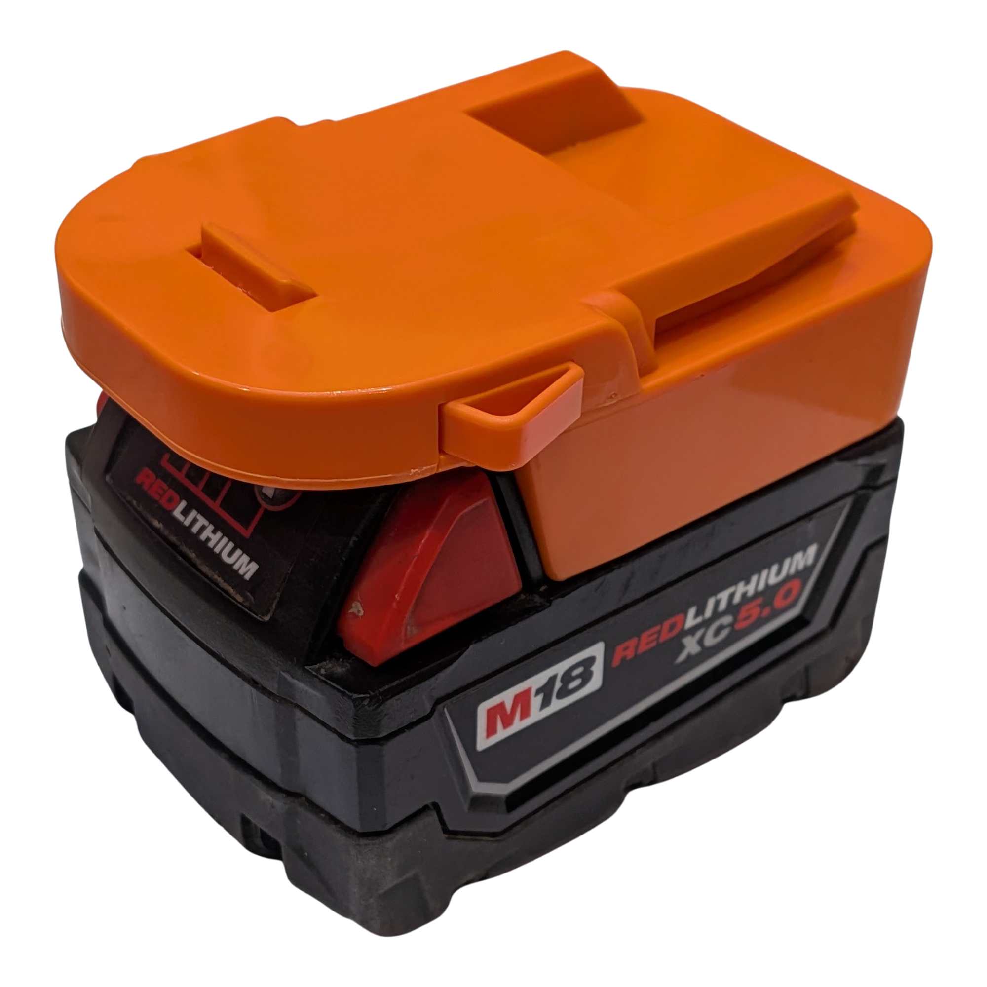 Milwaukee M18 to RIDGID 18V battery adapter - fitted to the Milwaukee M18 battery, orange body and latch seen from above